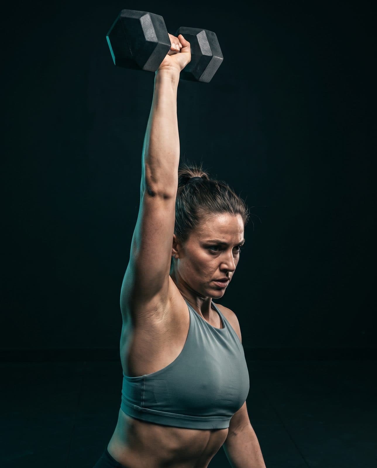 An overhead dumbbell press, mid-rep